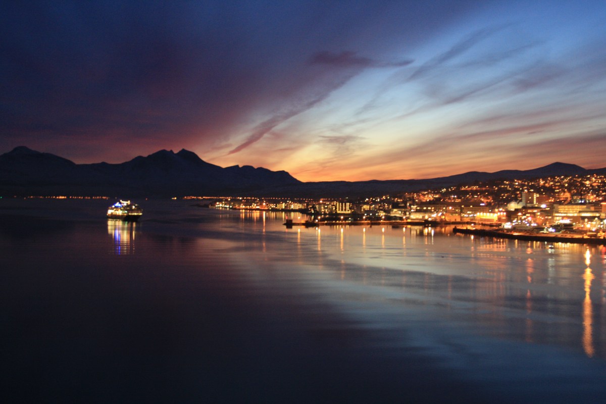 Winter: And the light disappears over Tromsø as the Hurtigruten boat arrives.